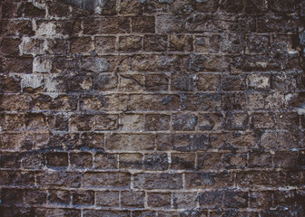 Closeup of old grey and rough dark sandstone wall. For pattern, texture and background