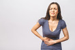 © denis_vermenko - Young beautiful woman having abdominal pain isolated on white background.