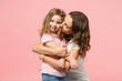 © ViDi Studio - Woman in light clothes have fun with cute child baby girl. Mother, little kid daughter isolated on pastel pink wall background, studio portrait. Mother's Day, love family, parenthood childhood concept