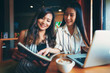 © Chanchai - Two beautiful girls with coffee Talk at the coffee shop
