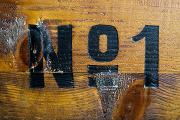 All the glamour is gone: Number one painted on old wood box