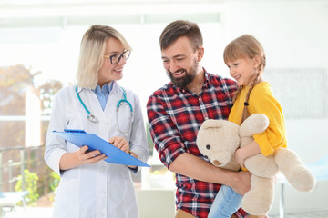 Wall Mural - Little girl with father visiting children's doctor in hospital