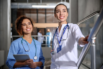 Wall Mural - Happy medical students in modern college hallway