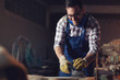 © zorandim75 - Carpenter sanding with electric sander polisher