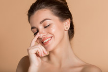 Happy Smiling Girl With Perfect Skin With Moisturizing Face Cream On A Cheek. Skin Care And Health Concept.