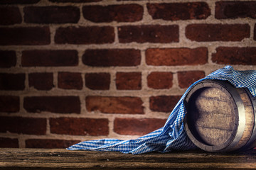 Wall Mural - Oktoberfest wooden barrel and blue tablecloth on rustic oak table