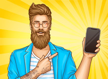 Bearded Hipster Man With Tattoos Wearing Fashioned Clothing And Round Glasses Point With Index Finger On Smartphone In Other Hand. Vector Illustration On Yellow Background In Pop Art Retro Comic Style