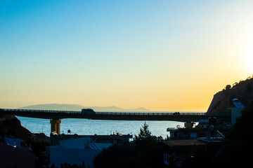 Car on the bridge against the sea