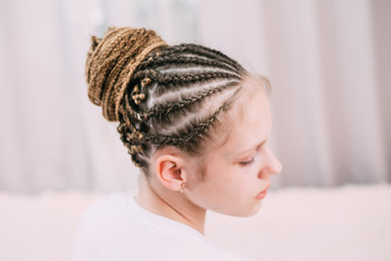 the girl with the brown hair and the braids with kanekalon braided