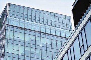 Facade fragment of a modern office building. Exterior of glass wall with abstract texture.