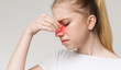 © Prostock-studio - Sad woman holding nose because sinus pain
