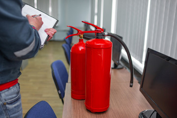Wall Mural - engineer professional are checking a fire extinguisher using clipboard or checking industrial fire c