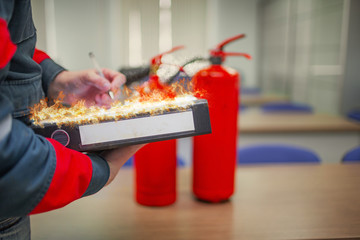 Wall Mural - engineer professional are checking a fire extinguisher using clipboard or checking industrial fire c