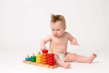 smiling kid girl playing with toy isolated on white background,baby girl 6 months old with wooden toy on white background,educational games for children