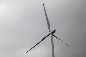 Wind generator turbine or windmill or wind farm, cloudy foggy day