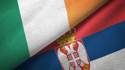 Ireland and Serbia two flags textile cloth, fabric texture