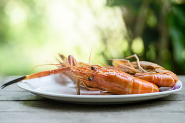 Closeup grilled shrimps on the white plate delicious seafood on the wood table or background