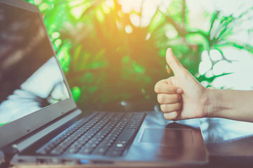 Woman hand using laptop and smartphone to work study with cafe shop colorful beautiful bokh background. Business, financial, trade stock maket and social network concept.