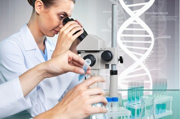 Wall Mural - Female Scientist Working with Microscope in Laboratory