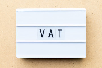 Canvas Print - White lightbox with word VAT (Abbreviation of value added tax) on wood background