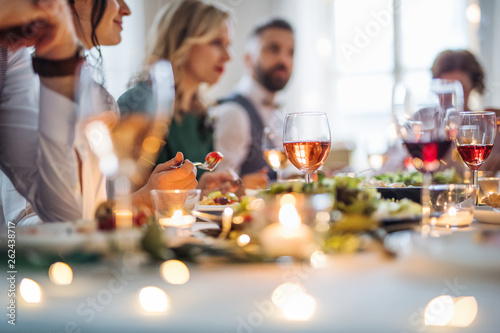 Cuadros en Lienzo A big family sitting at a table on a indoor birthday party, eating