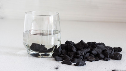 Russian shungite stones on a white background used in alternative medicine for water purification and recharge due to high carbon content and metaphysical properties