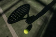 Paddle tennis player shadow in ball in court