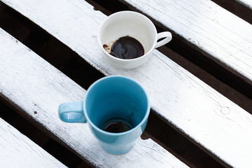 Wall Mural - Fragrant coffee in a beautiful cup. Cup outdoors on a wooden table.