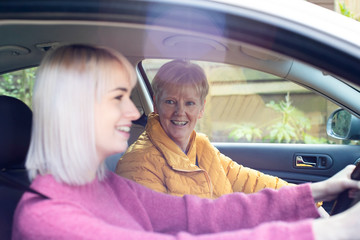 Wall Mural - Female Neighbor Giving Senior Woman A Lift In Car