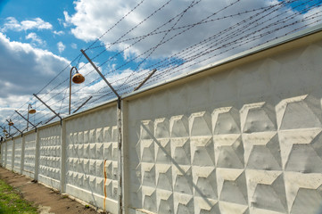 Wall with barbed-wire with electricity.