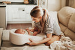 Home portrait of happy mother and newborn baby