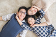 © Nattakorn - Happy Asian family laying with happy and smile, top view
