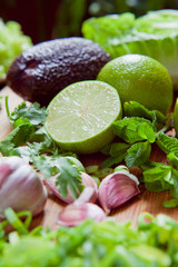 Sticker - Green fruit and vegetable - wooden board with green food  ingredients: garlic, avocado, lime, mint, cilantro, leek, green chili peppers.