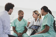 © ReeldealHD images - Medical professionals discussing patient treatment in a hospital