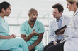 © ReeldealHD images - African American medical professional discussing patient treatment in a hospital