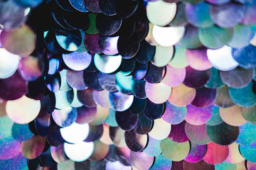 Shiny abstract background of semicircular multi-colored plastic elements of sequins texture fashion. Neon trend colors.