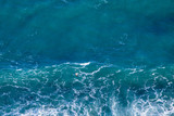 Fototapeta  - Blue sea texture with waves and foam