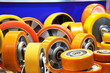 Group of different size and diameter industrial small wheels in warm yellow and orange colors for sale. Heavy Duty Fixed Polyurethane Industrial trolley Swivel Rubber Caster Wheels.