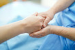 © amazing studio - Holding Touching hands Asian senior or elderly old lady woman patient with love, care, helping, encourage and empathy at nursing hospital ward : healthy strong medical concept