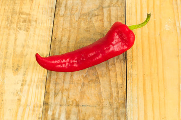 Red pepper on dirty wooden background