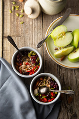 Wall Mural - Healthy breakfast.Two bowls of muesli with oats, nuts and dried fruits - apples, resins, pumpkin seeds and almonds on wooden table. Top view. Rustic style.