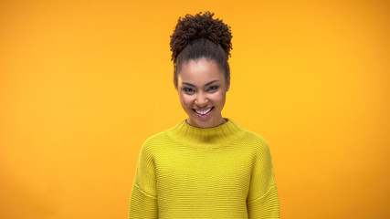 Wall Mural - Happy young female in yellow sweater bright background, pretty modern teenager