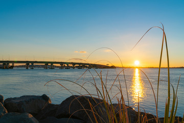 Canvas Print - Sunrise  glows across harbor