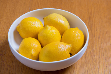 Fresh yellow lemons on a wooden background.. sweet lime, vitamin c.