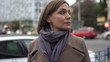 © motortion - Worried woman standing on busy street, looking around waiting for appointment