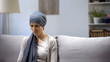 Upset woman with cancer lonely sitting in hospital, alone with her illness