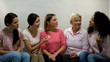 © motortion - Women with pink ribbons chatting, group of support breast cancer patients health