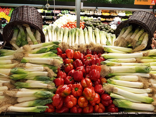 Wall Mural - Colorful red peppers among vegetables, vegetables at the market