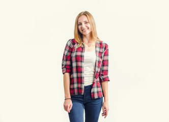 Wall Mural - Beautiful happy young woman standing on a light background, photo toning.