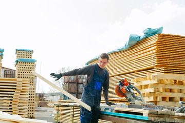 Work sawing boards. Sawmill. wood harvesting process